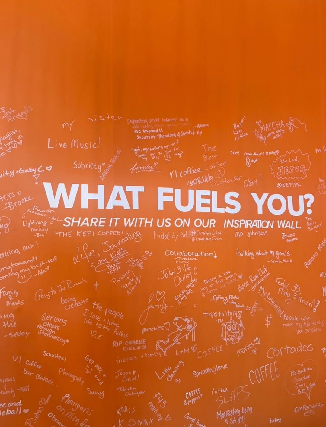 The orange inspiration wall at KEFI HQ — What fuels you?